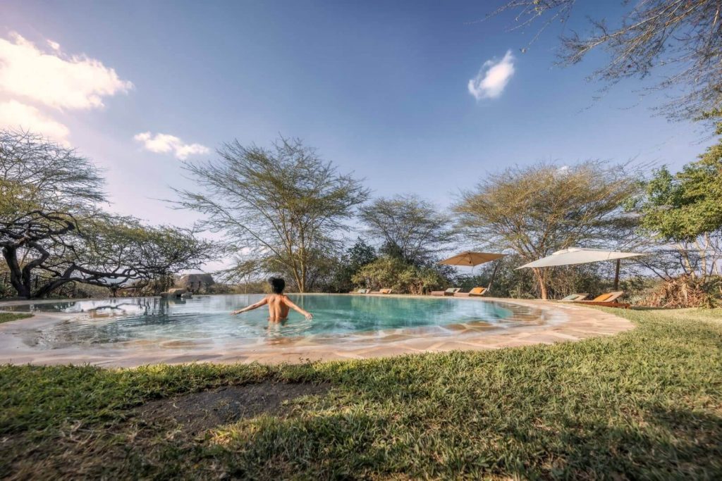 Elewana Lewa Safari Camp - SwimmingPoolWithGuestWide Szenisch Africa Safaris & Expeditions